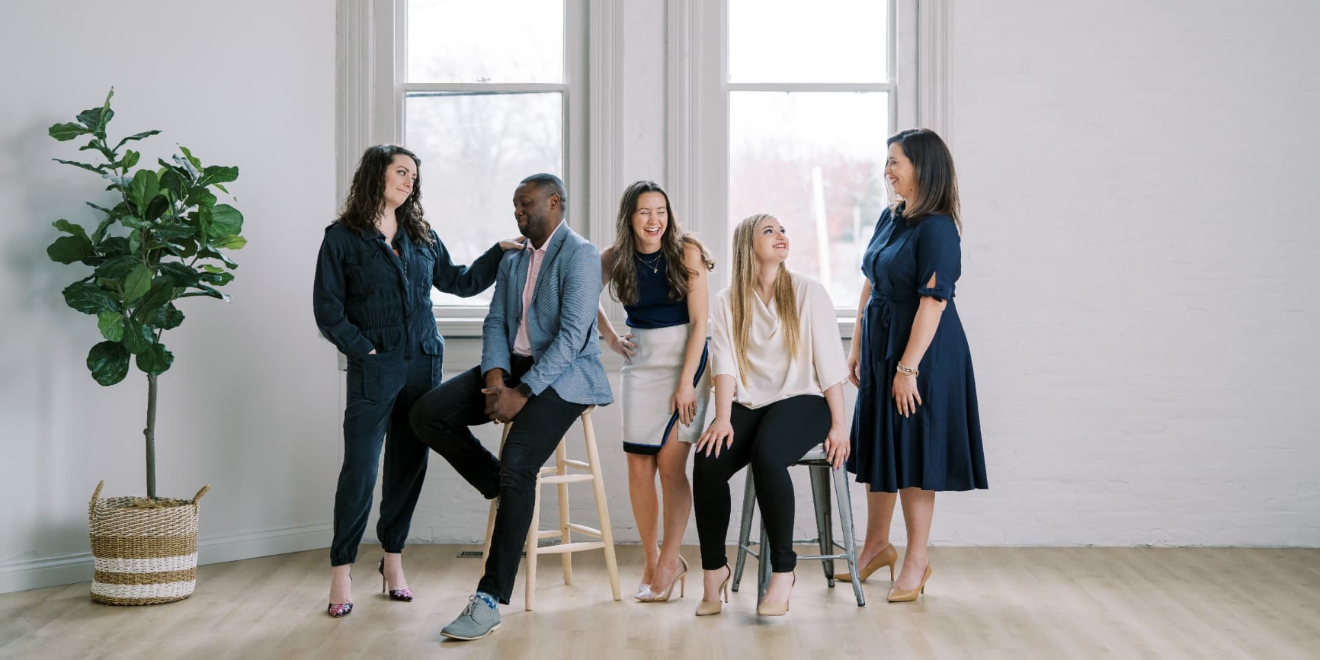 The Teloscope team standing together in a bright studio with tall windows